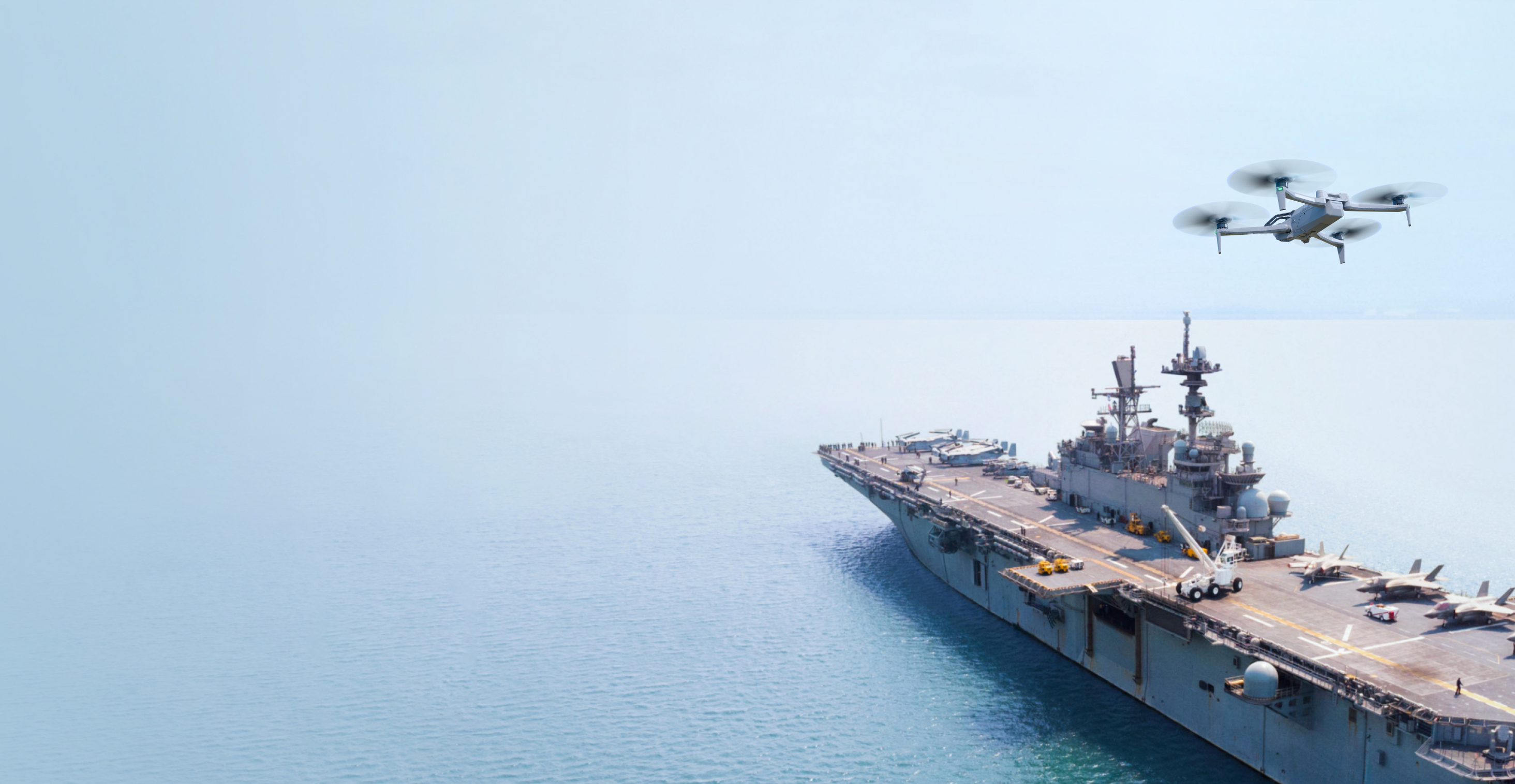 Skydio inspection drone flying over an aircraft carrier