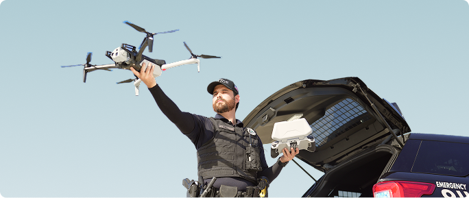 patrol officer hand launching a Skydio X10 police drone